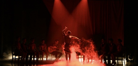 Frau auf einer rotbeleuchteten Bühne 