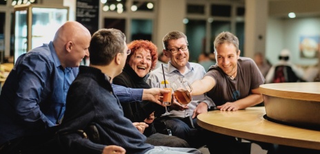 Auf dem Bild sind Menschen mit Behinderung in Interaktion mit ihren Assistenzen zu sehen.