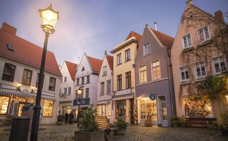 The Schnoor quarter in the evening. The lights shine in the shops. 