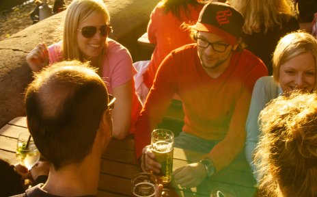 A group sits sociably in a beer garden at Schlachte