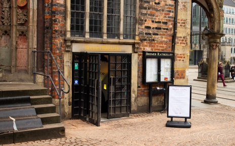 Eingang des Bremer Ratskellers am Rathaus mit geöffneten Türen und historischer Backsteinfassade.