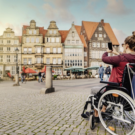 A wheelchair user takes photos on the market square.