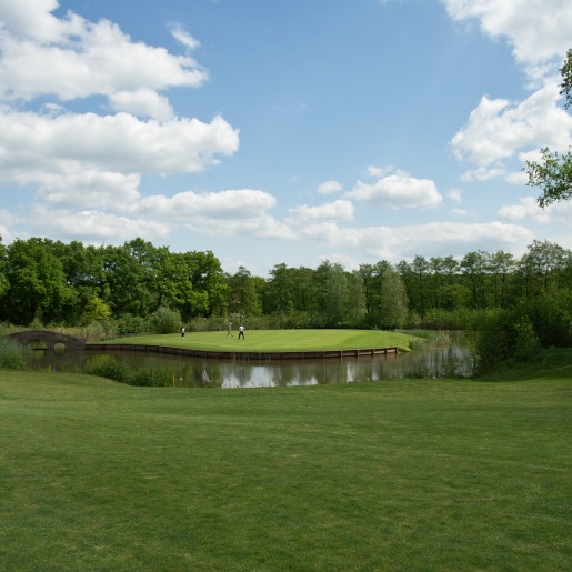 Drei Golfer stehen auf der grünen Anlage des Golfclubs Bremer Schweiz.