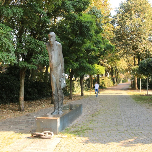 Die Bronze-Skulptur Zur Schicht steht in Gröpelingen an der Lindenhofstraße, Ecke Dockstraße.