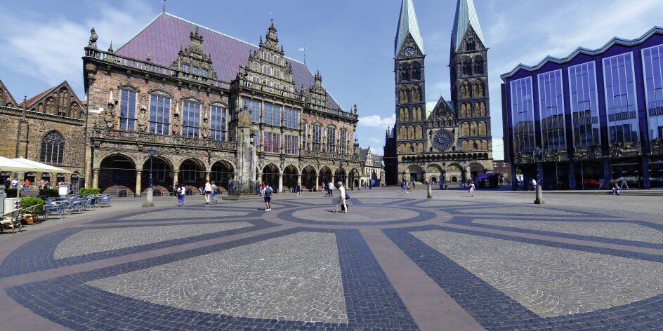 Der Bremer Marktplatz mit dem Rathaus, dem Dom mit zwei Türmen und der Bürgerschaft mit seiner großen Glasfront. 