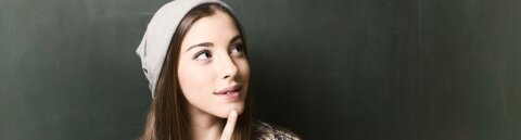 Young woman in front of a blackboard