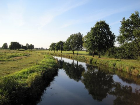 Watercourse, surrounded by meadows.