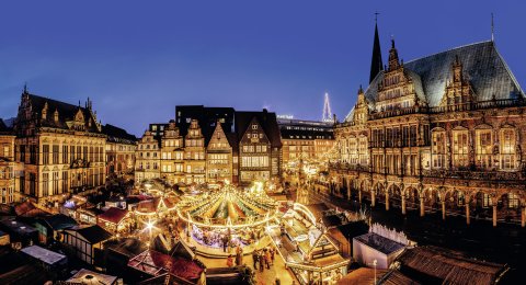 Beleuchtete Buden und ein Karussell auf dem Bremer Marktplatz zur Weihnachtszeit.