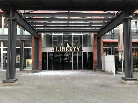 Eine Außenaufnahme des Eingangs am Hillmannplatz. Über dem Eingang steht in großen Buchstaben "Liberty".