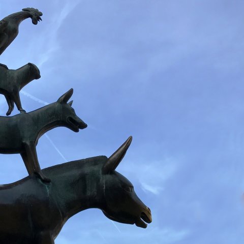 Die Statue der Bremer Stadtmusikanten vor blauem Himmel