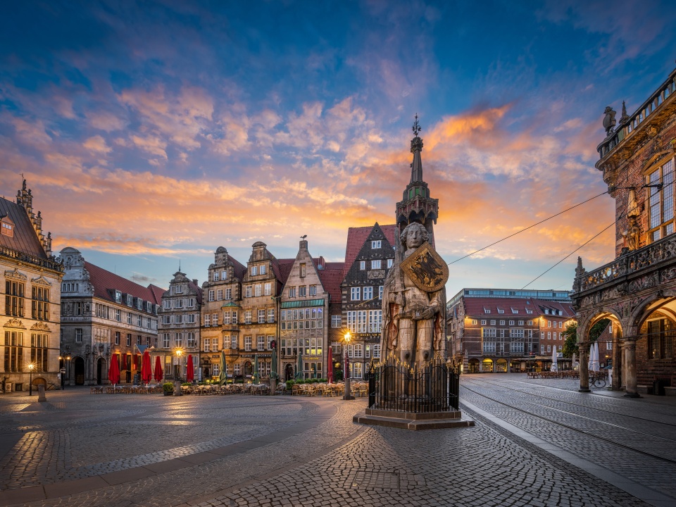 Ein Blick auf den Roland, auf dem leicht beleuchteten Marktplatz in der Dämmerung.